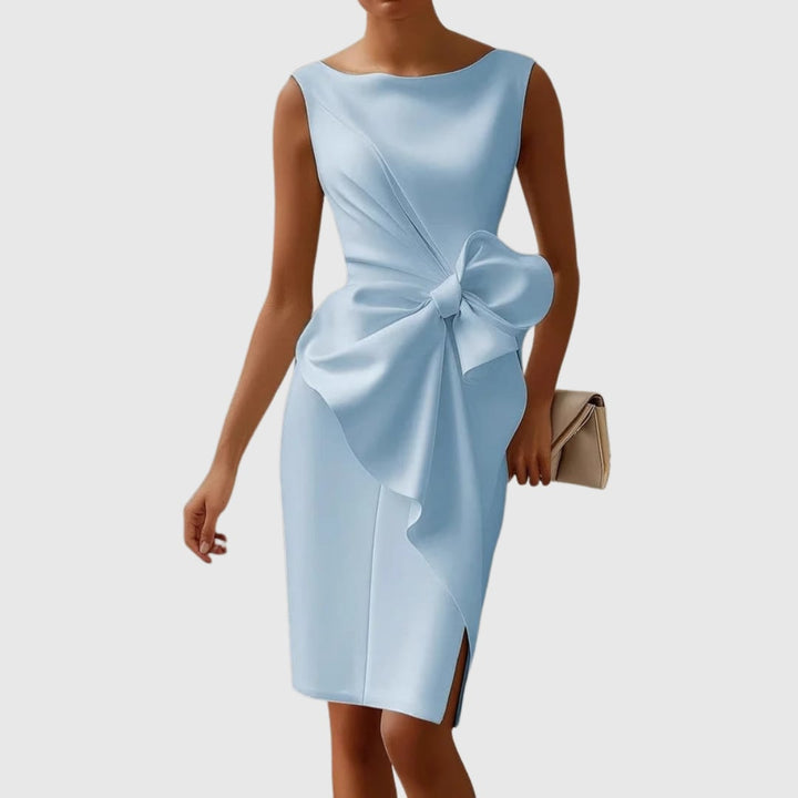 Close-up of the sculptural side bow and cascading fabric drape on the Eloise midi dress