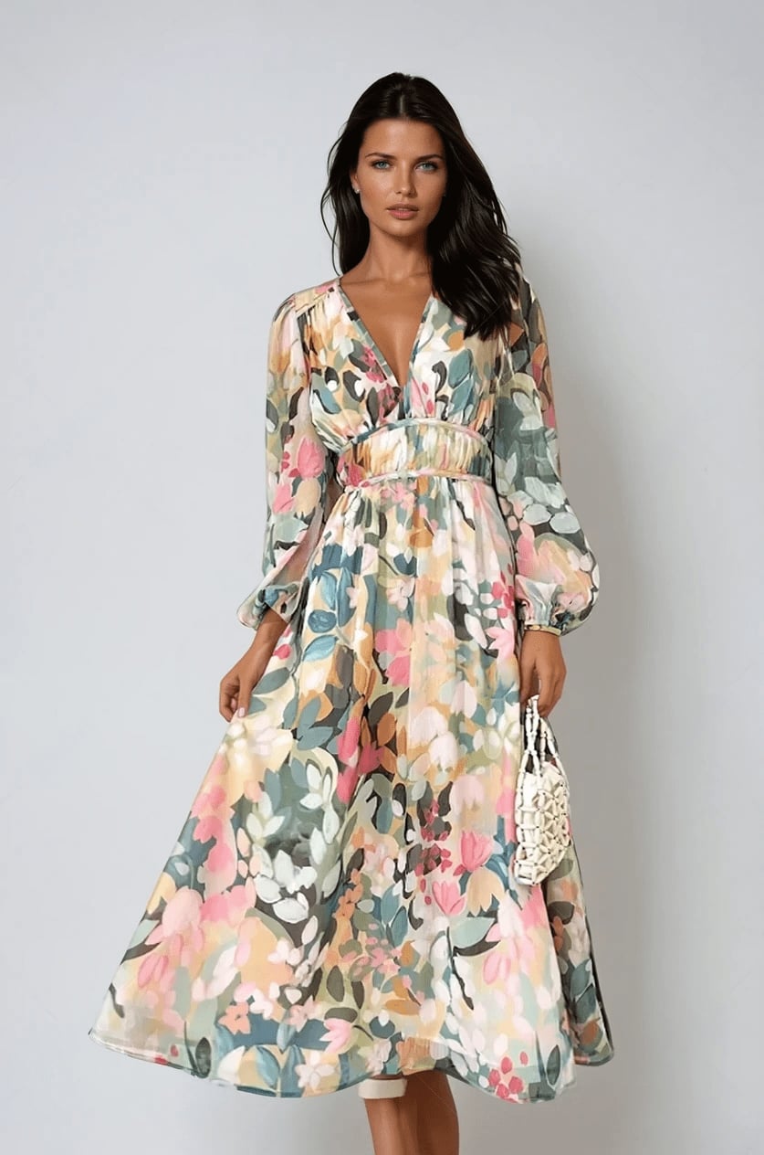 Woman wearing the Eloise floral midi dress in a multicolor watercolor print with a deep V-neckline, billowy long sleeves, and a flowing A-line skirt