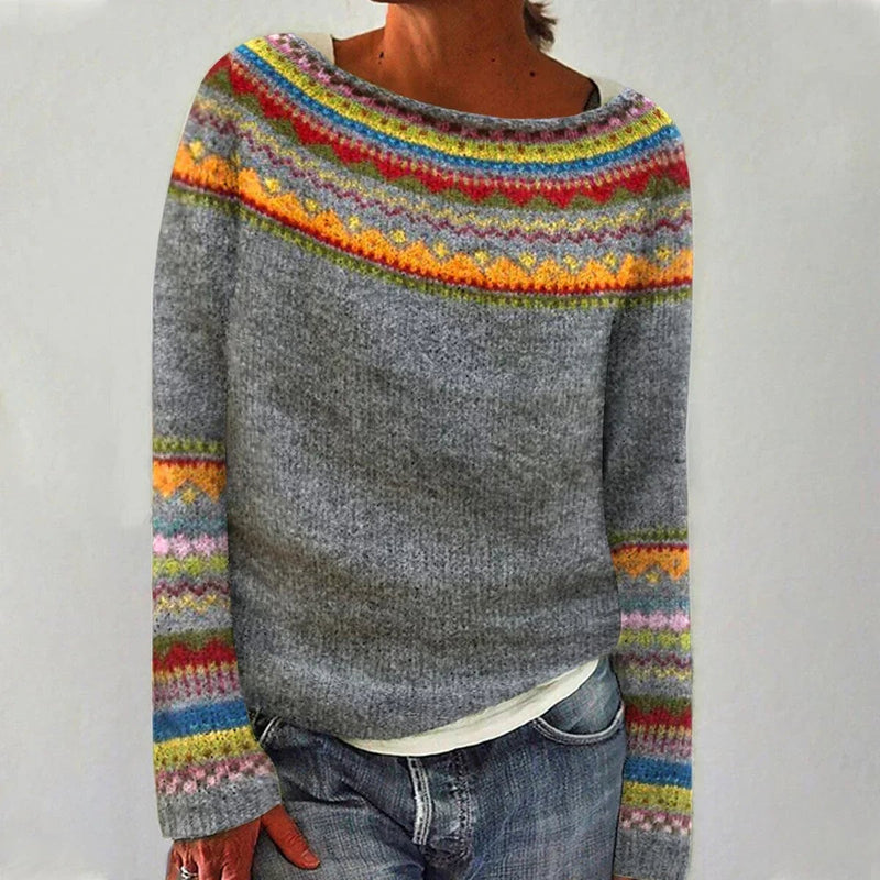 Woman wearing the Elora elegant Nordic sweater in a grey and rainbow multicolor pattern with a relaxed fit and boat neckline