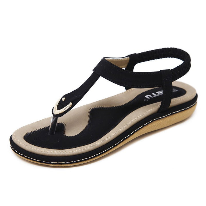 Elowen flat sandals in black showing cushioned footbed and non-slip outsole detail