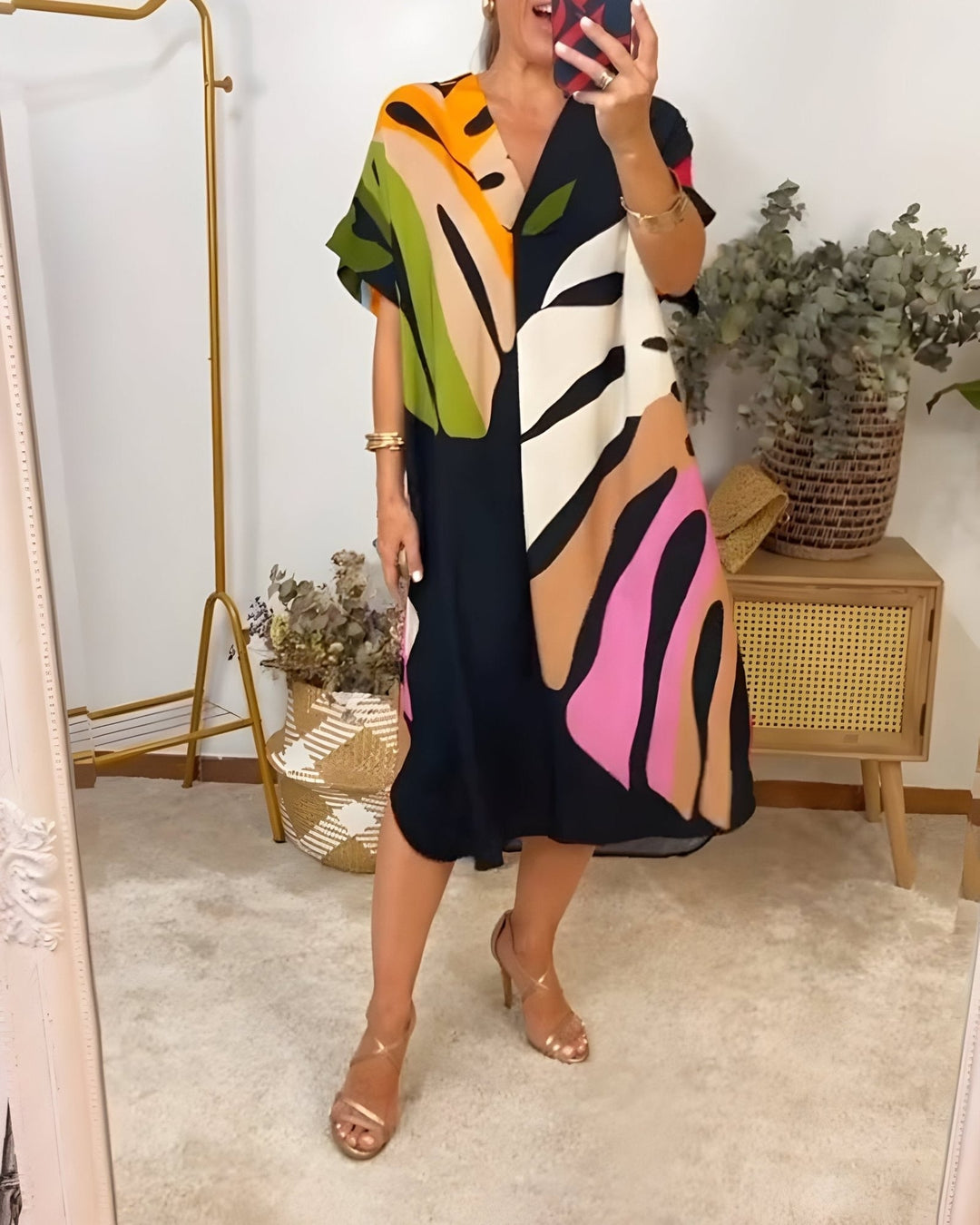 Woman wearing the Elsie casual summer dress in a relaxed outdoor setting, showing the full-length lightweight silhouette