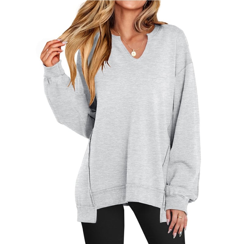 Side view of the Ember V-neck sweatshirt tunic in pink highlighting the tunic length and ribbed hem detail
