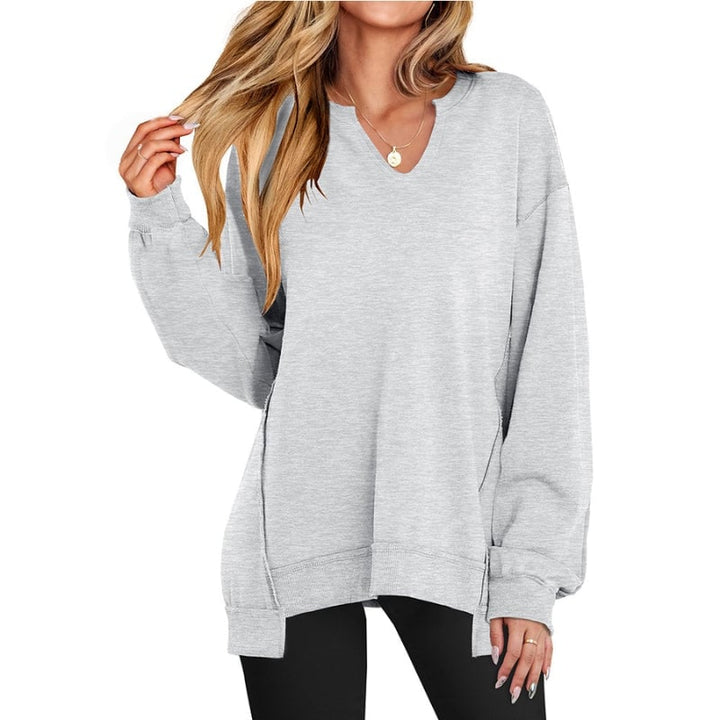 Side view of the Ember V-neck sweatshirt tunic in pink highlighting the tunic length and ribbed hem detail