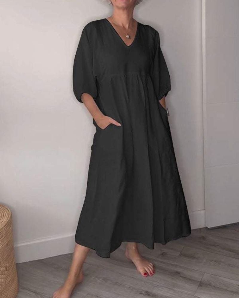 Close-up detail of the Emery V-neck maxi dress showing the flowing fabric and flattering neckline