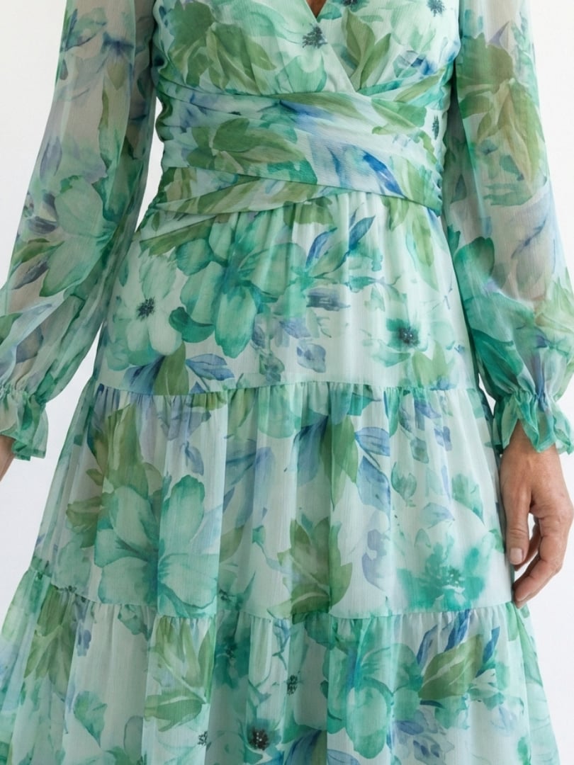 Close-up of the V-neckline detail on the Emilia floral maxi dress in green