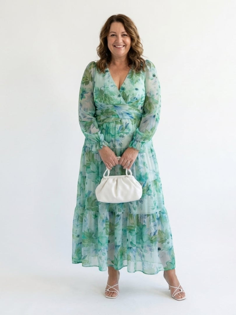 Back view of the Emilia green floral maxi dress showing flowing silhouette and long sleeves