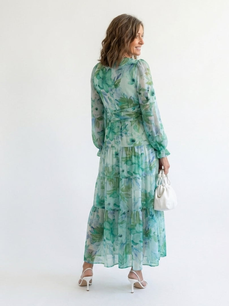 Woman posing in the Emilia orange floral maxi dress, front full-length view