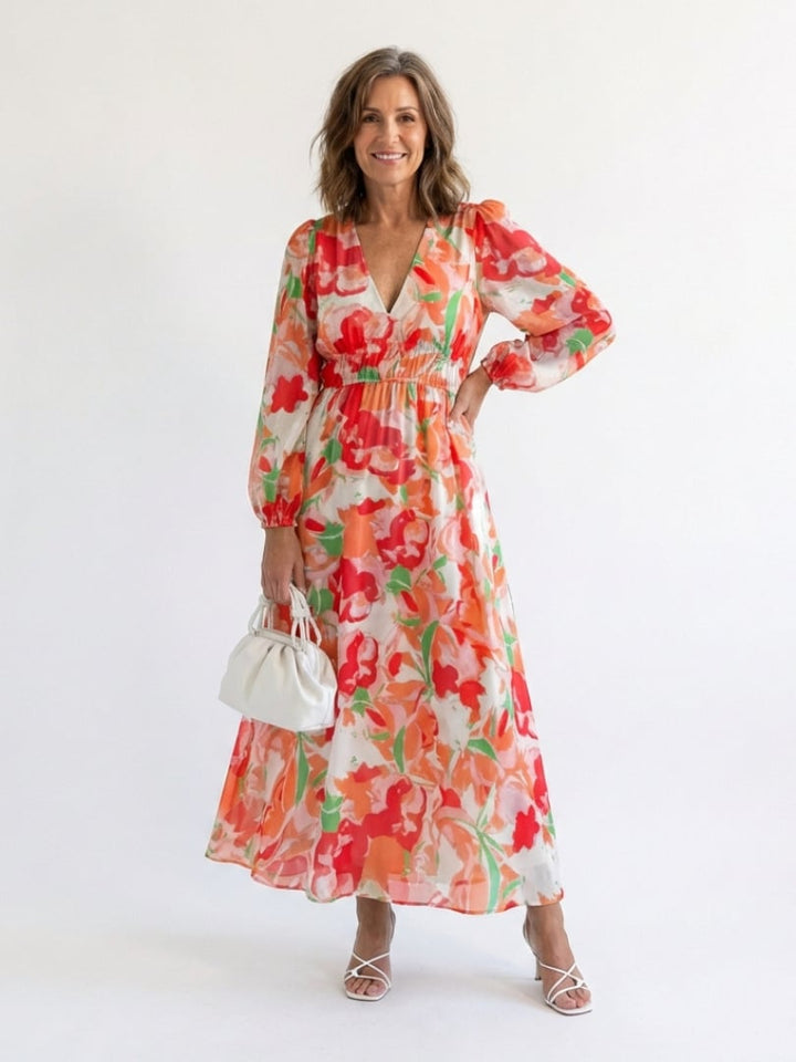 Side view of the Emilia orange floral maxi dress highlighting the floor-sweeping hem