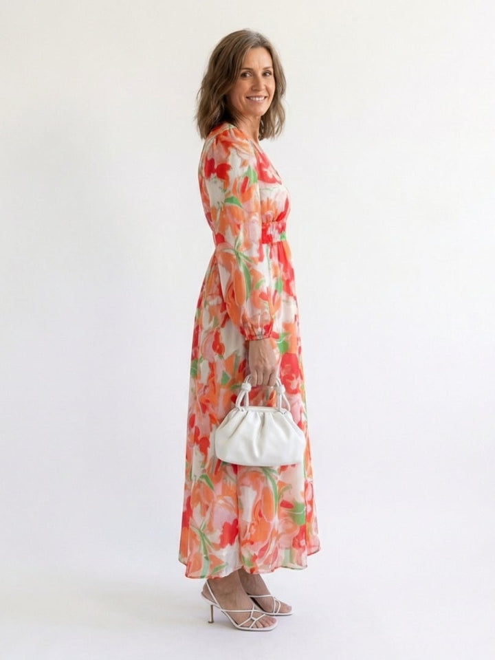 Woman wearing the Emilia blue floral maxi dress, full-length front view