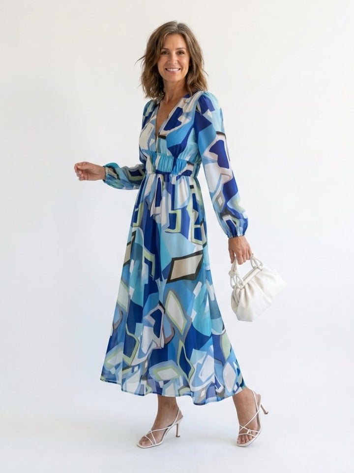 Back view of the Emilia blue floral maxi dress showing graceful drape