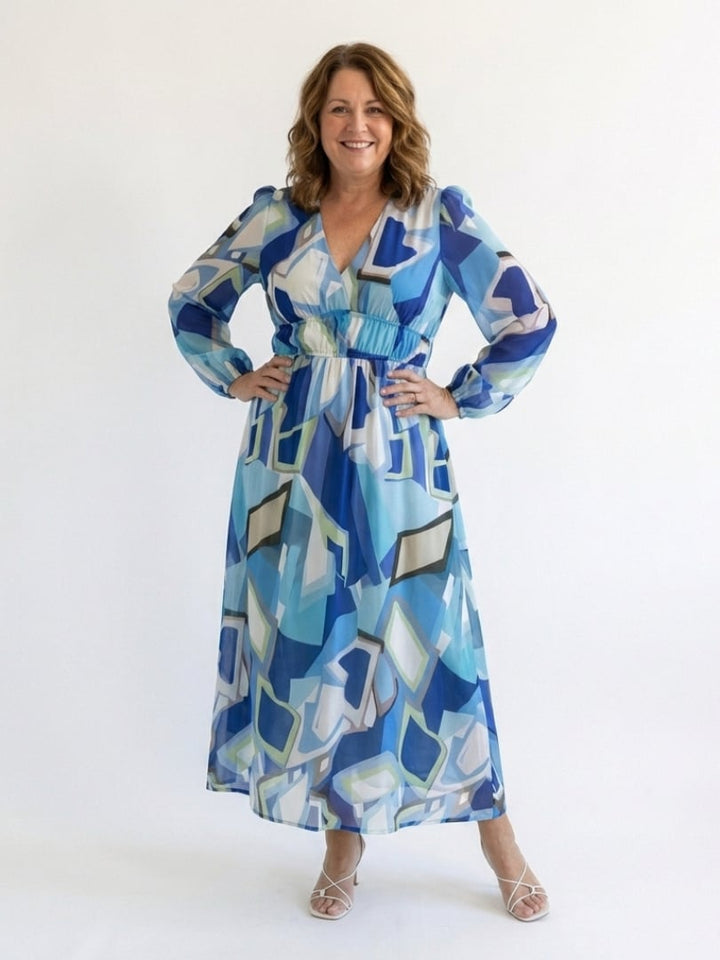 Side profile of the Emilia floral maxi dress in blue with flowing fabric