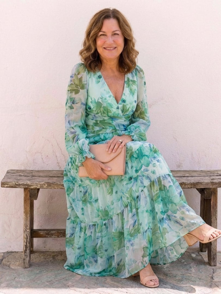 Woman in the Emilia green floral maxi dress styled with sandals outdoors