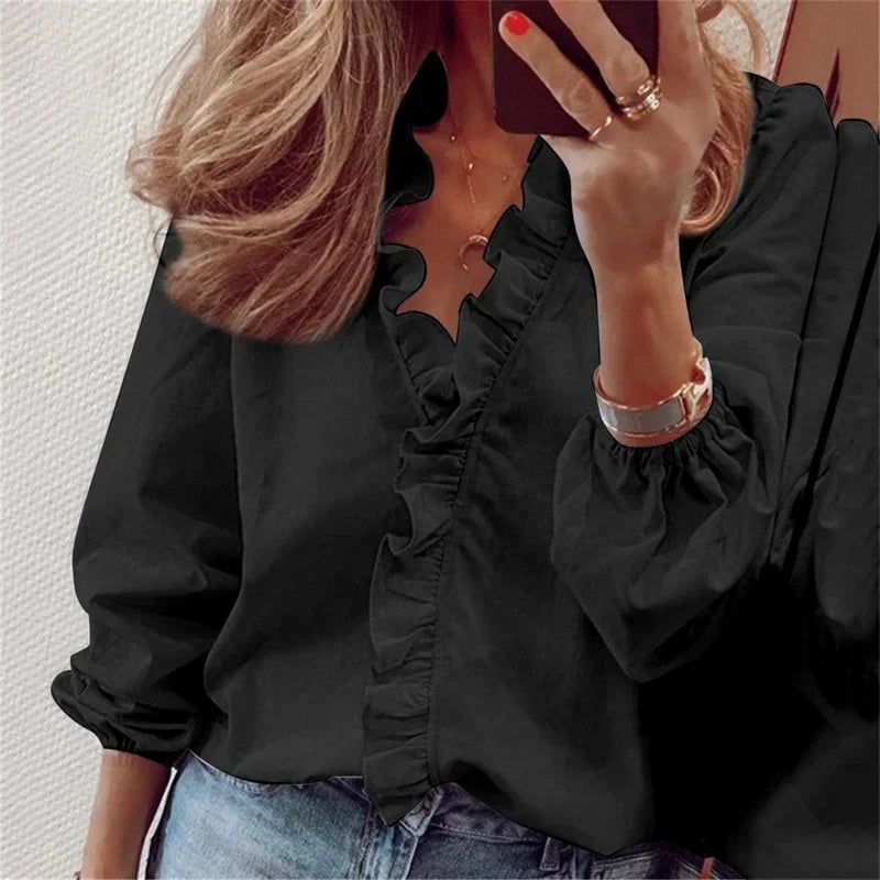 Feminine ruffle blouse in orange colorway with elegant balloon sleeves, modeled front facing