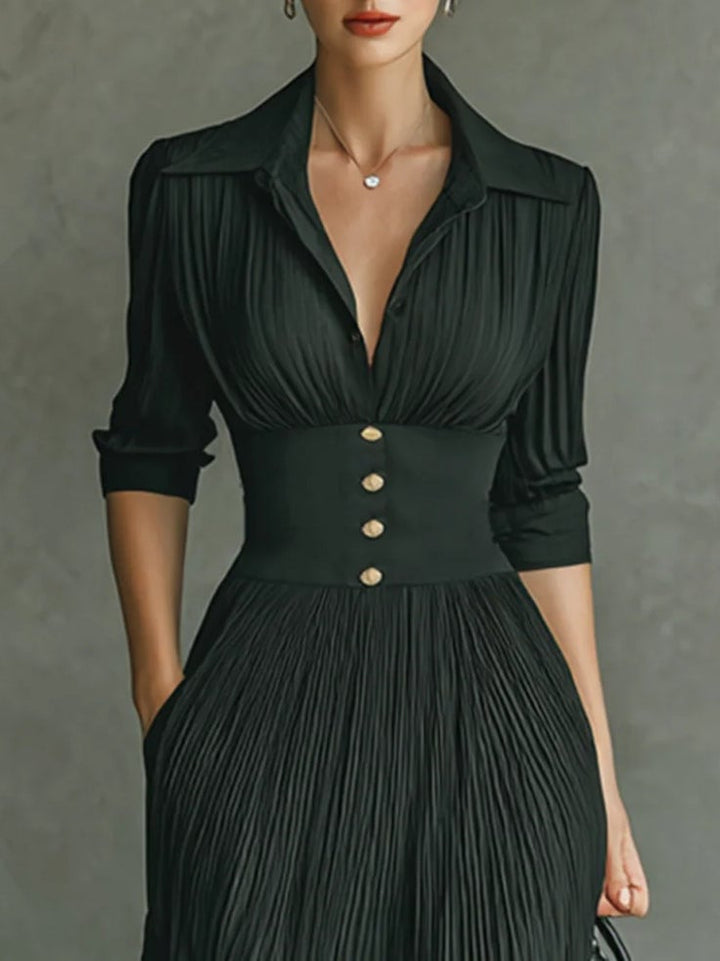Woman in a black chic fitted waist dress styled for an evening occasion, side profile view