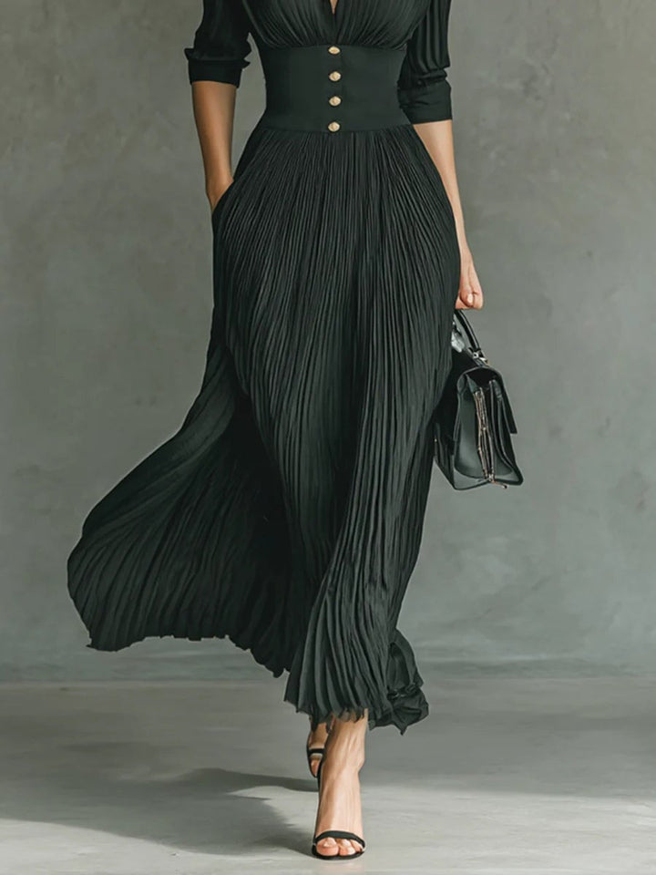 Full-length back view of a black fitted waist dress highlighting the sleek, polished silhouette