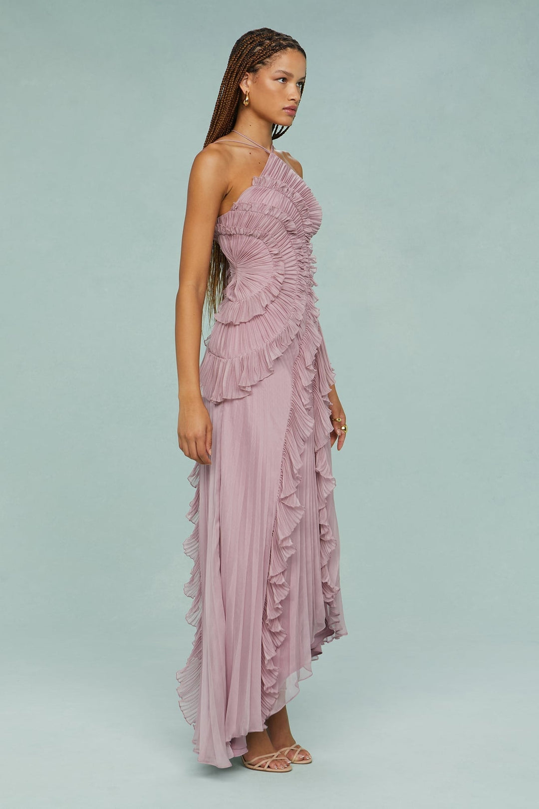 Model wearing the Estelle halter dress at an outdoor garden party setting