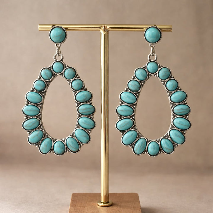 Turquoise earrings shown from a side angle highlighting their silhouette and color