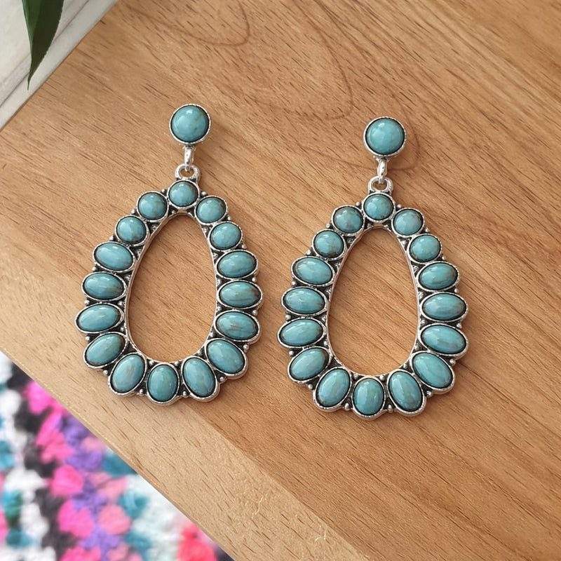 Lifestyle shot of turquoise earrings styled for a summer occasion
