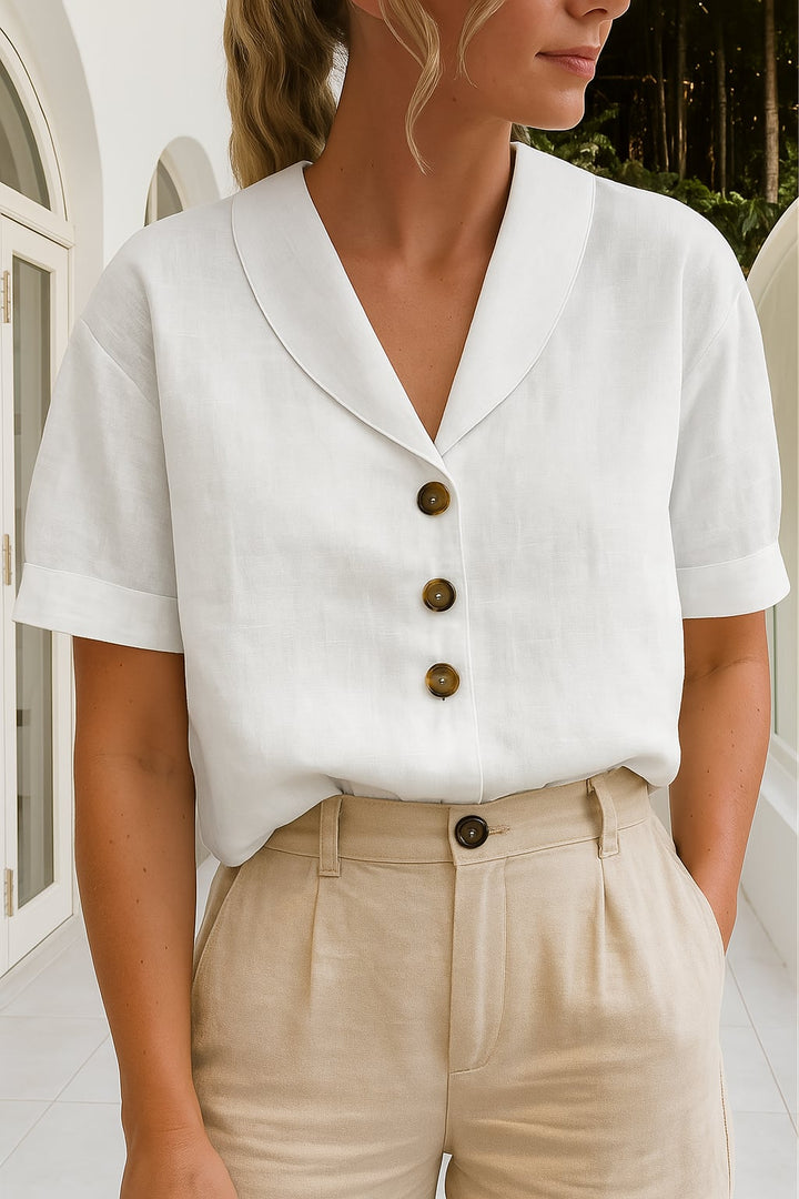 Woman wearing the Ethel elegant wrap neckline blouse in white, styled with high-waist trousers for a polished daytime look
