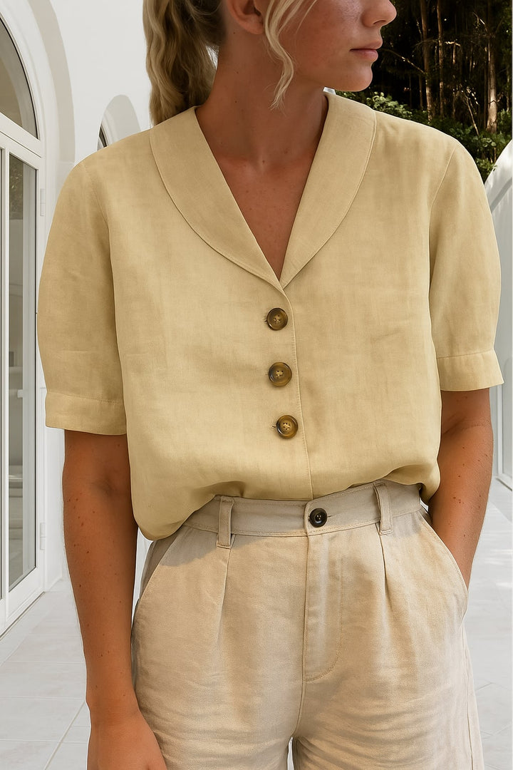 Close-up of the Ethel blouse wrap neckline detail showing feminine draping in a neutral beige colorway