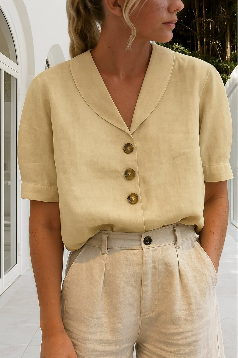 Close-up of the Ethel blouse wrap neckline detail showing feminine draping in a neutral beige colorway