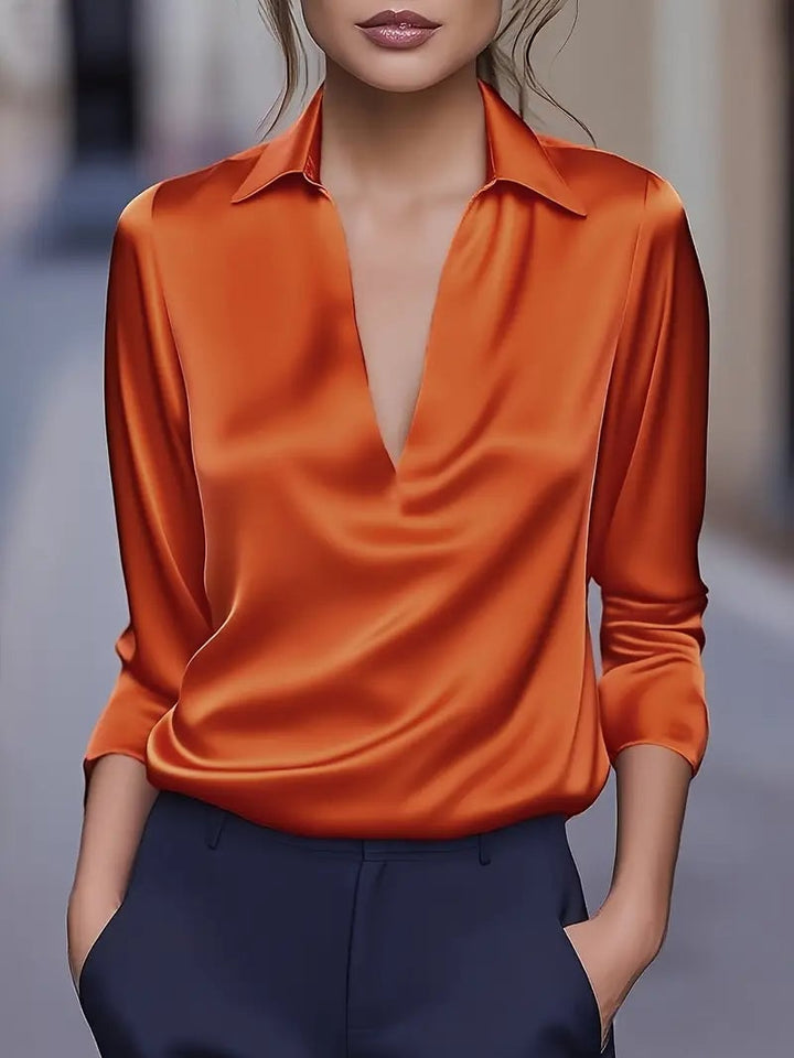 Orange V-neck satin blouse with lightweight fabric and polished look — front view