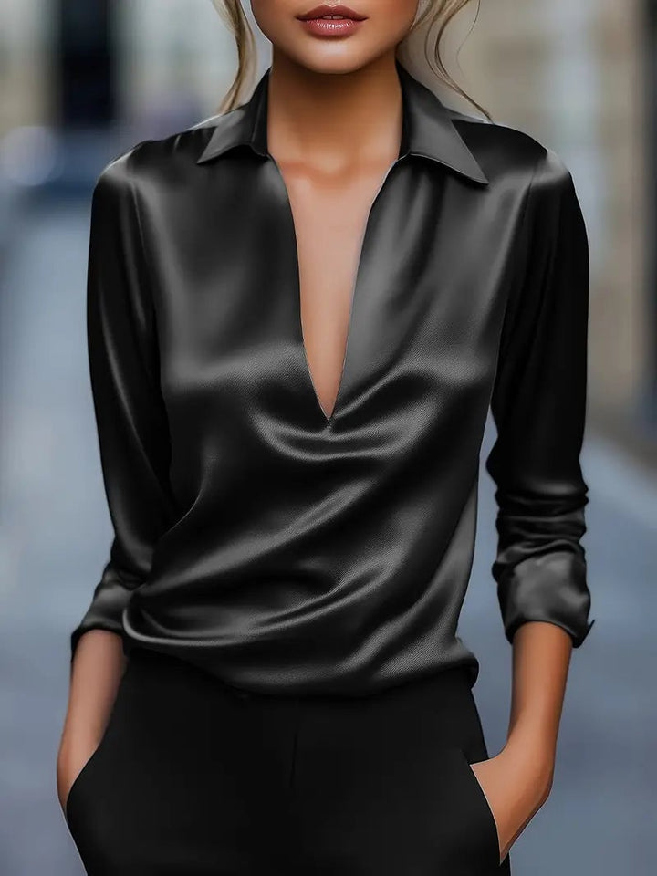 Light pink satin blouse close-up showing fabric texture and V-neckline detail