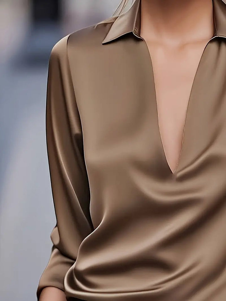 Green satin blouse layered under a blazer for office styling