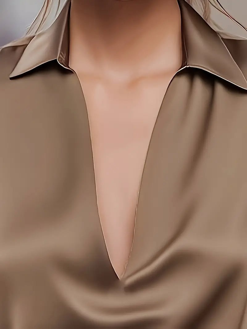 Orange V-neck satin blouse paired with denim jeans