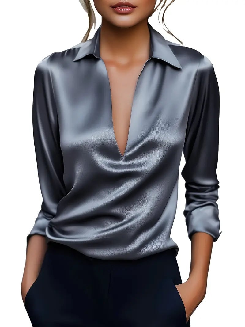 Green satin blouse neckline close-up showing V-cut detail