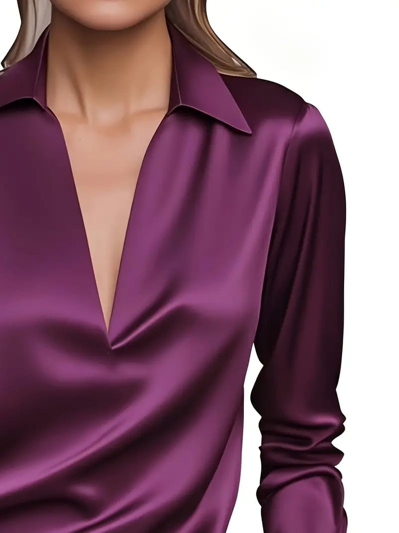 Orange satin blouse flat lay highlighting lightweight material
