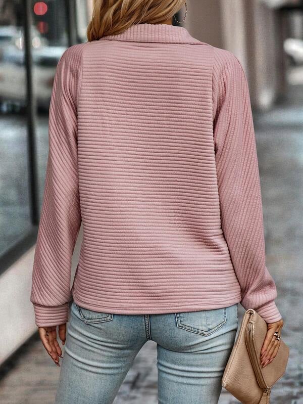 Detail shot of the soft knit fabric and zip closure on the Evangeline V-neck sweater