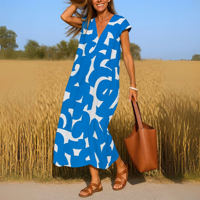Side view of the Evangeline V-neck flowy dress in blue highlighting the draped fit