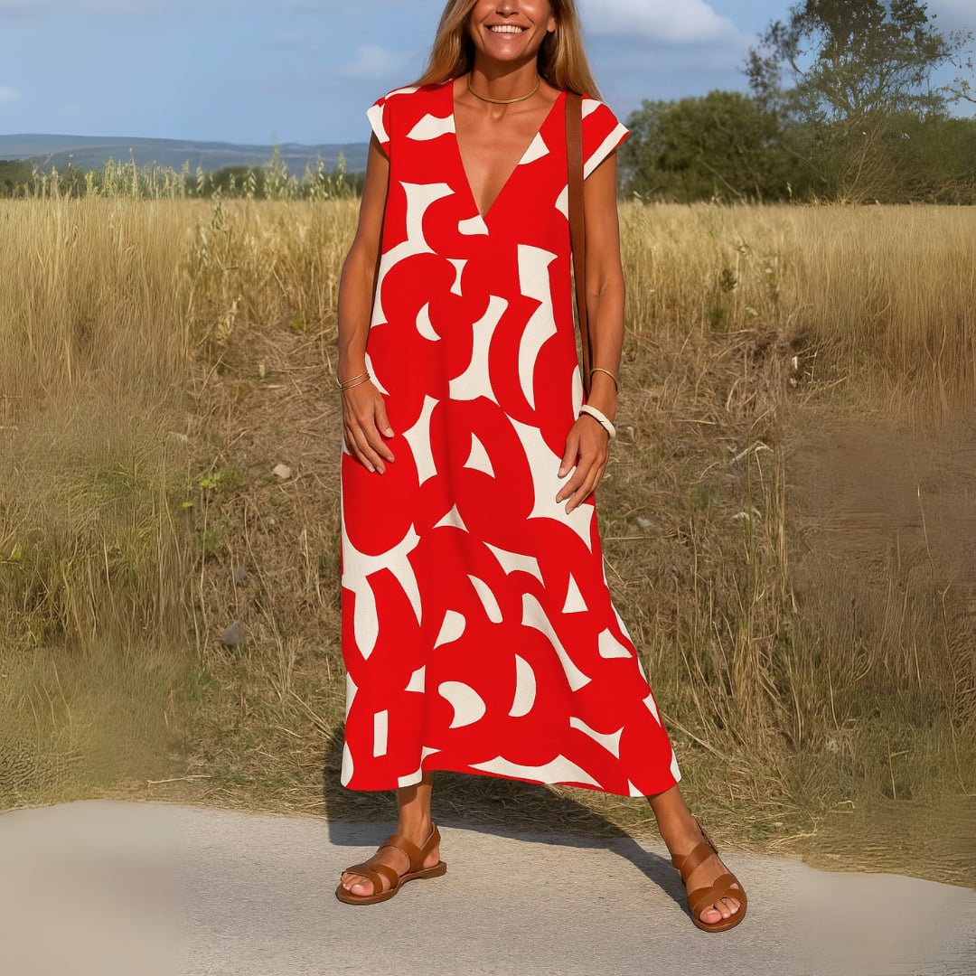 Woman posing in the Evangeline evening dress in red, showcasing the flowy skirt movement