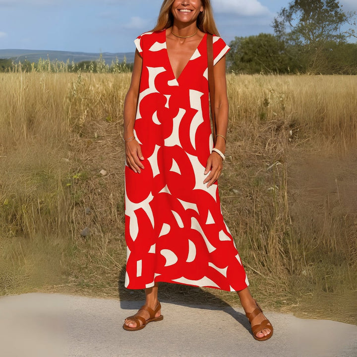 Woman posing in the Evangeline evening dress in red, showcasing the flowy skirt movement