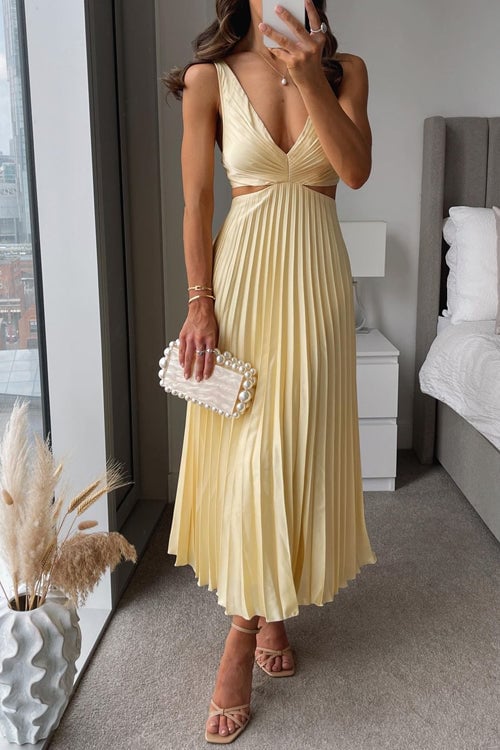 Woman wearing the Evangeline flowing maxi dress in a soft, elegant silhouette perfect for wedding guests