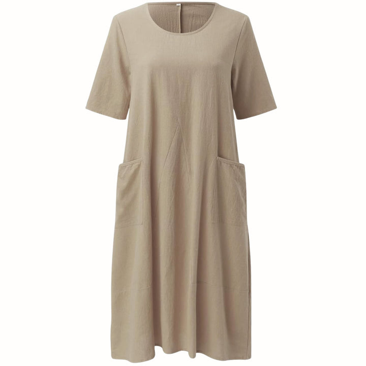 Evelyn relaxed fit dress in green showing the flattering, non-restrictive drape