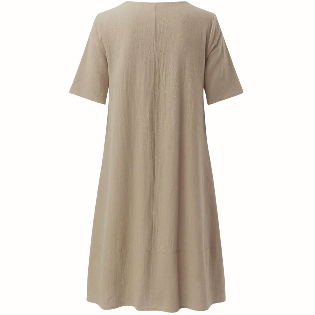 Evelyn relaxed fit dress in beige styled casually with flat sandals for a laid-back look
