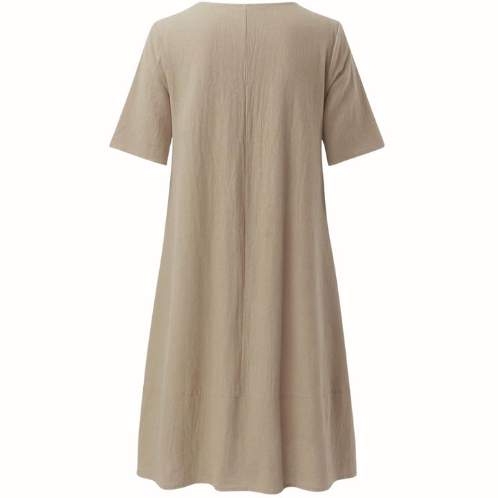 Evelyn relaxed fit dress in beige styled casually with flat sandals for a laid-back look