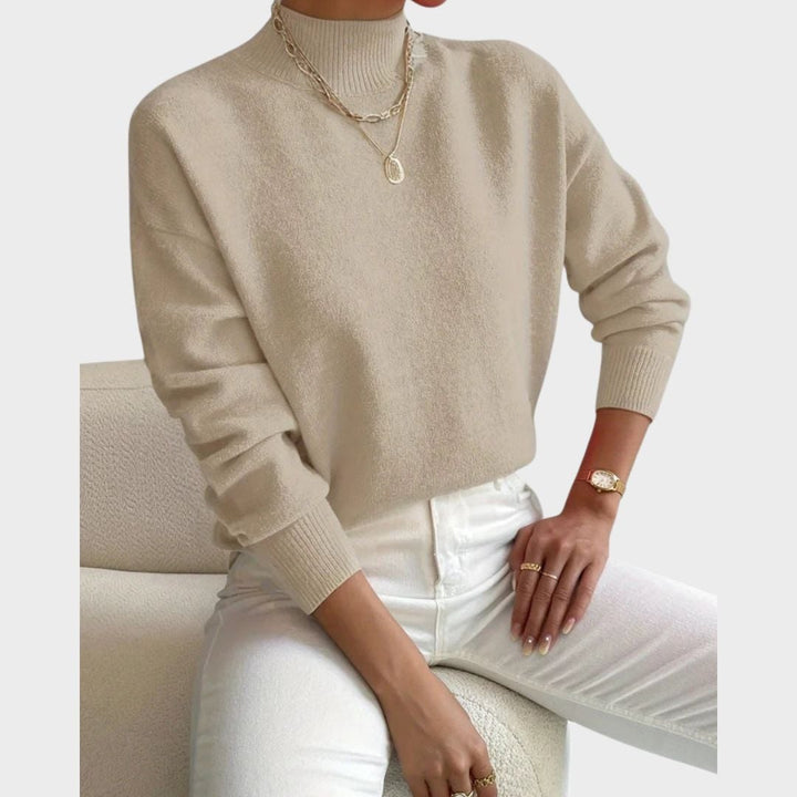 Front view of the Evelyn turtleneck sweater in beige, highlighting the flattering silhouette