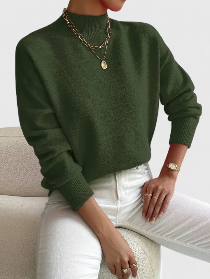 Model wearing the green Evelyn turtleneck sweater layered under a blazer