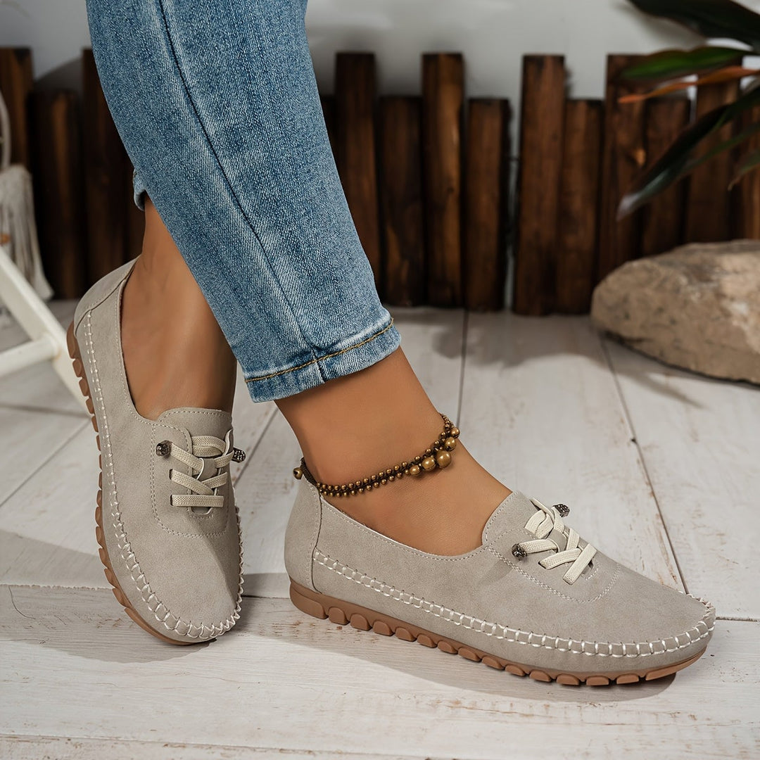 Evelyne loafers in beige worn with straight-leg jeans, lifestyle shot