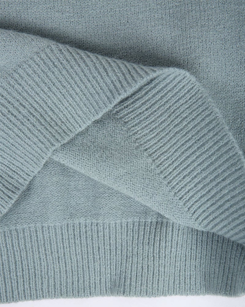 Model layering the Everly knitted sweater over an outfit for an elevated everyday look