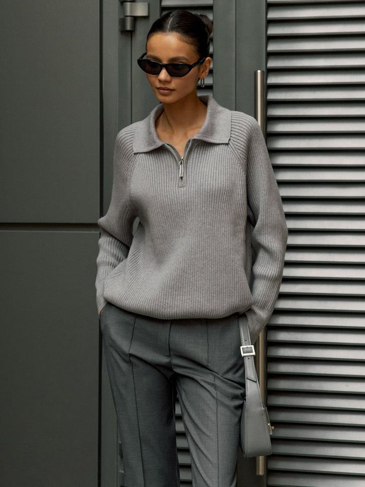 Model styling the Everly sweater in pink tucked into a midi skirt