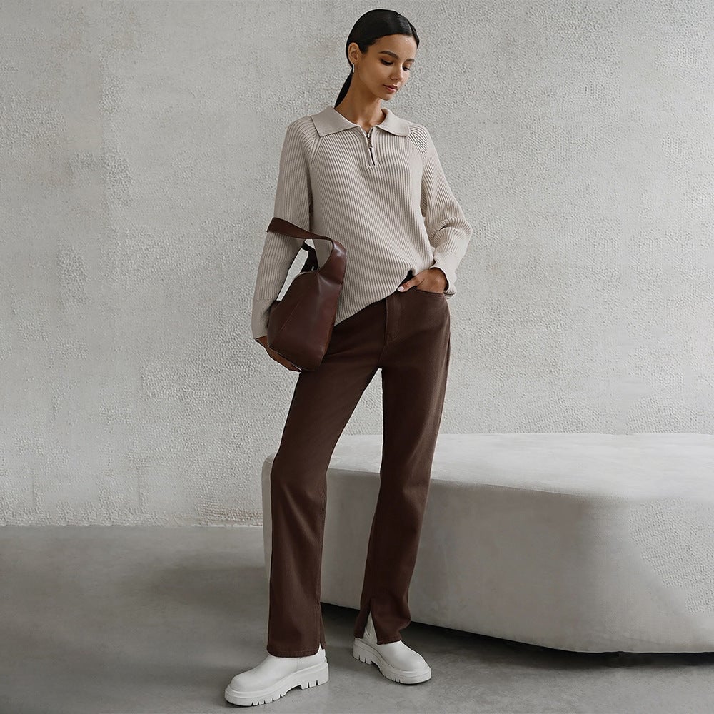 Full-length shot of model wearing the Everly sweater in gray with trousers