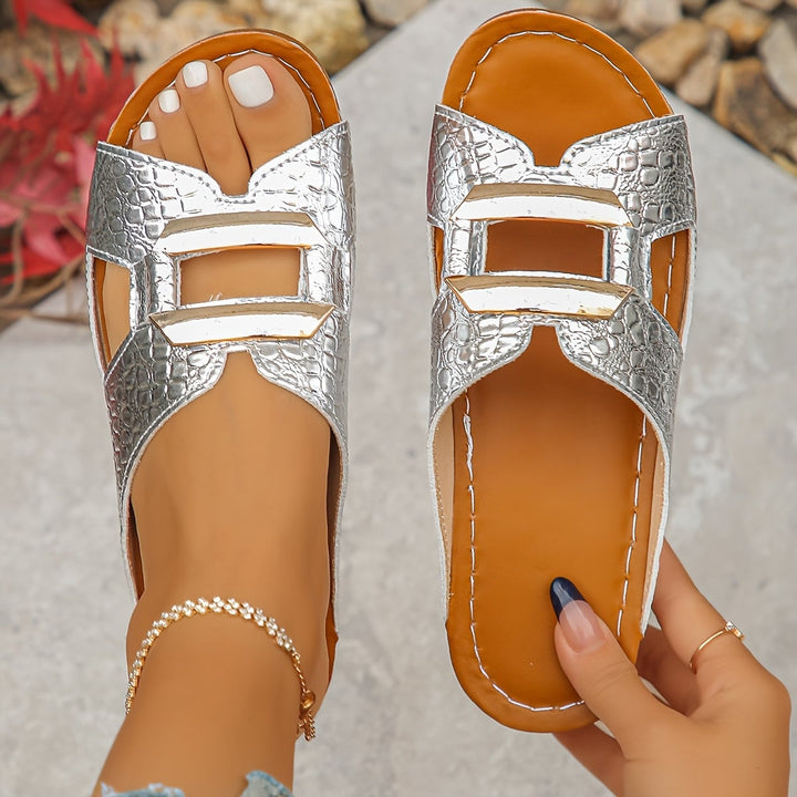 Side profile of Everly beige sandals showing flexible sole and buckle accent