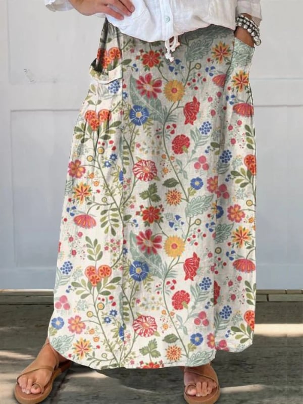 Multicolor floral print A-line skirt with elastic waistband and side pockets, shown in a flowing relaxed silhouette