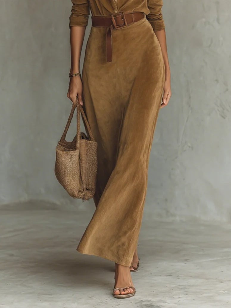 Full-length view of a brown suede maxi gown showing the flattering curve-skimming fit
