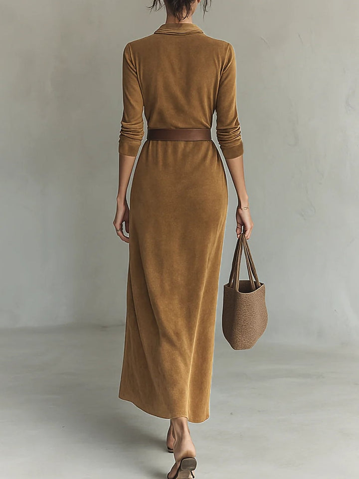 Overhead styling shot of the suede maxi gown paired with accessories on a neutral background