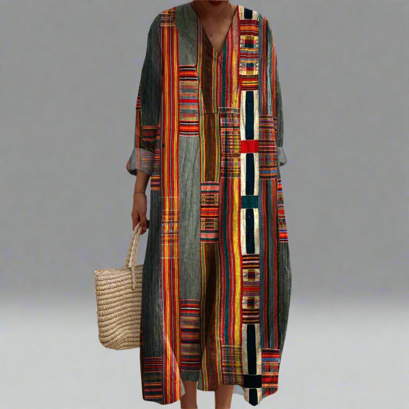 Woman wearing the Faith elegant geometric dress in a flowing silhouette with a bold dream-inspired geometric print
